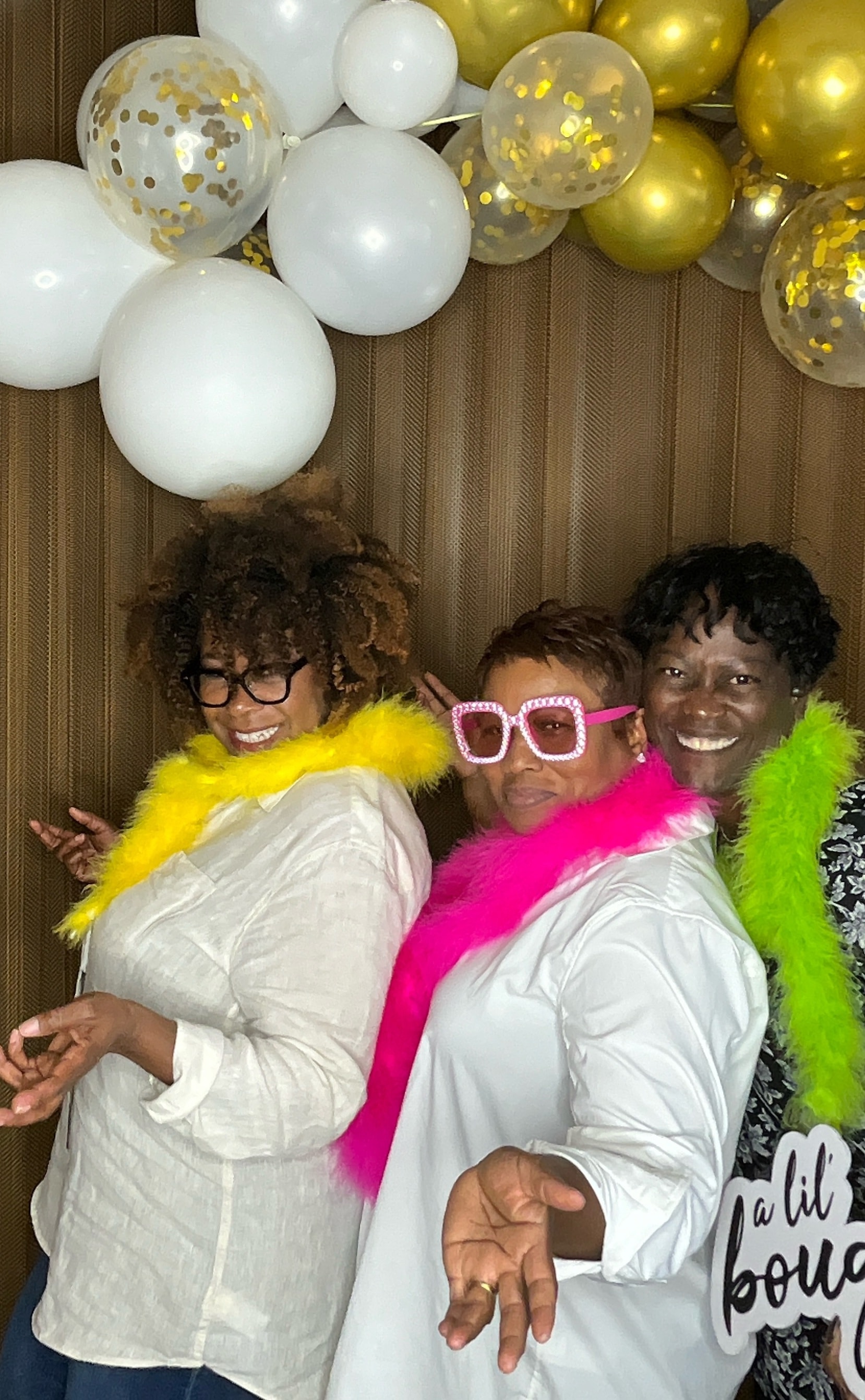 Friends posing with fun signs and props at photo booth